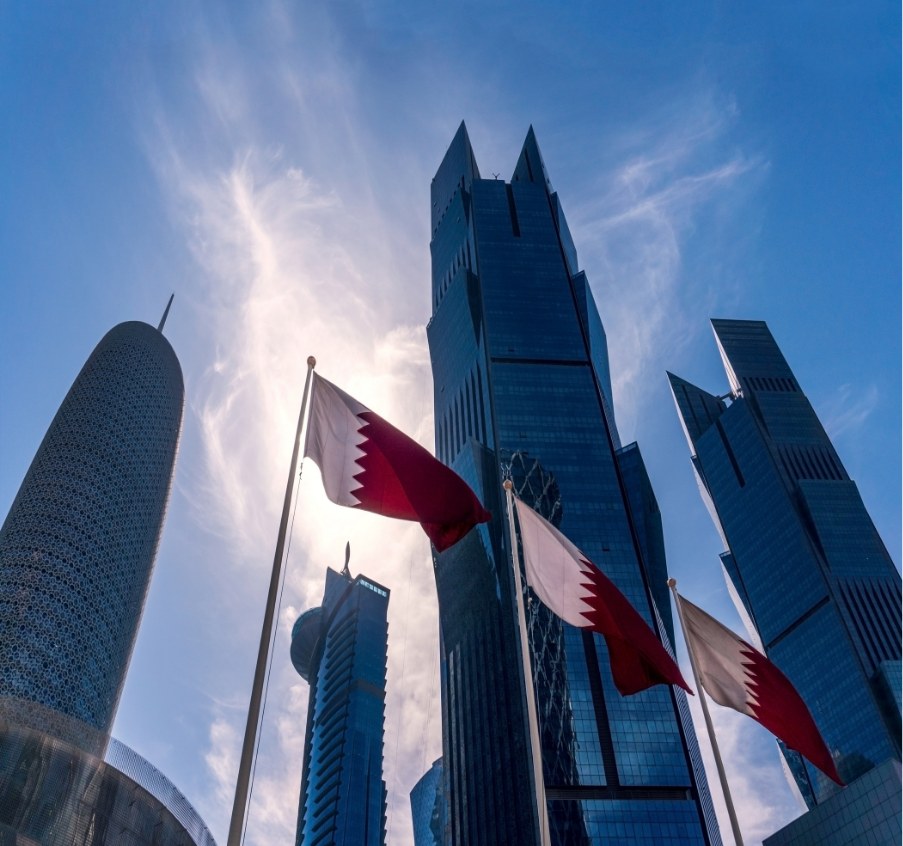 Qatari flags in front of Doha towers
